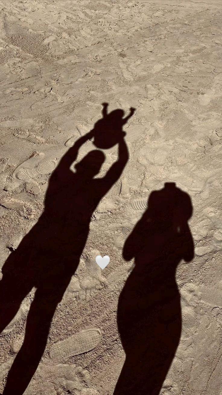 The shadow of a mother lifting her child